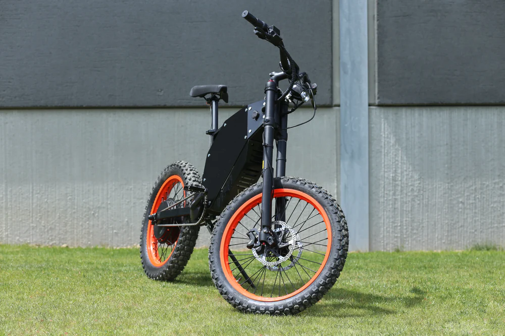 Vector Typhoon 10kw Electric Bike tackling a rugged off-road path with a rider.