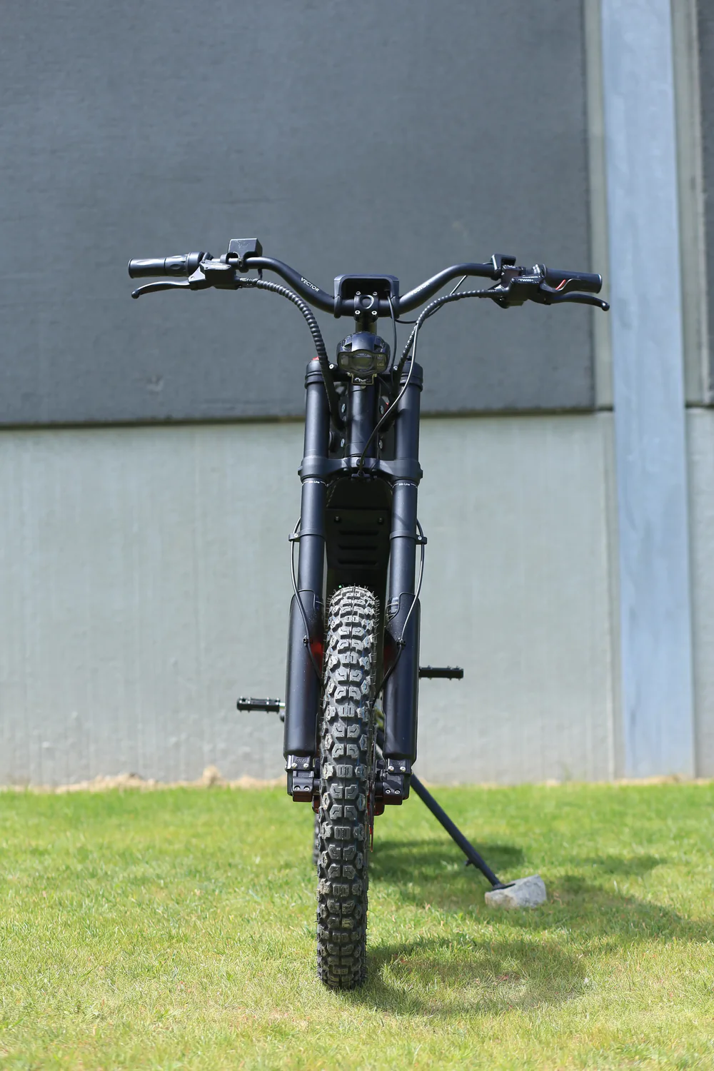 alaria X3 Pro 5kw Electric Bike transitioning from urban street to a light off-road trail in Europe.
