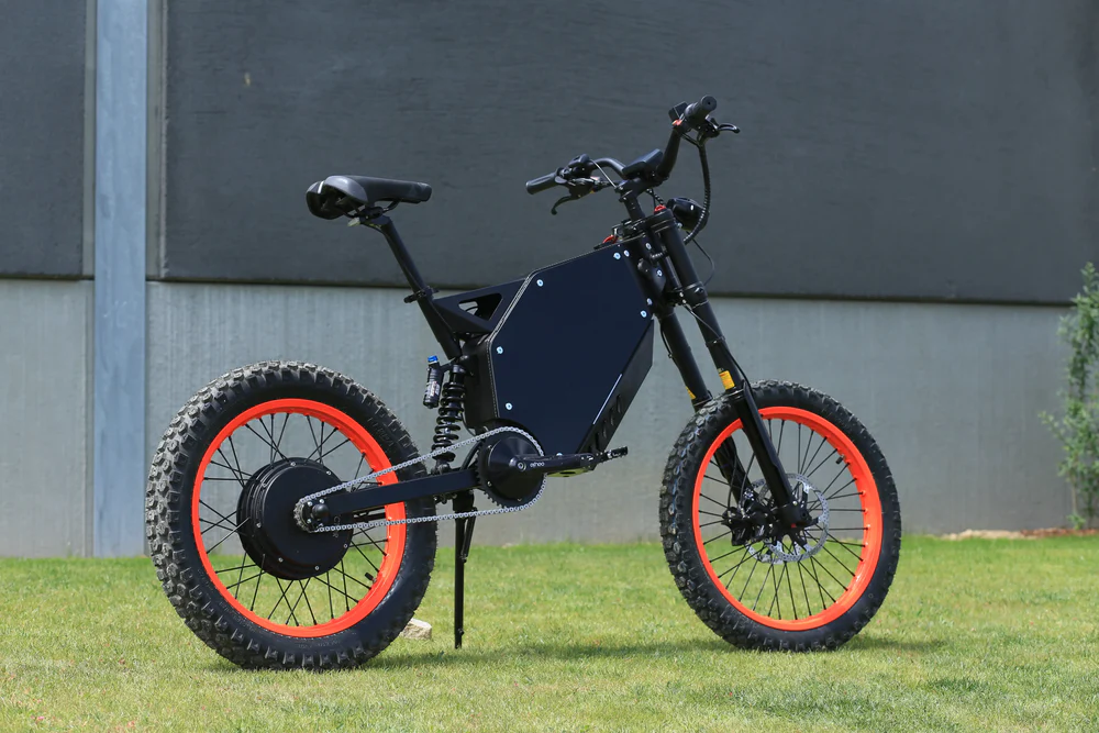 Vector Typhoon 10kw Electric Bike tackling a rugged off-road path with a rider.